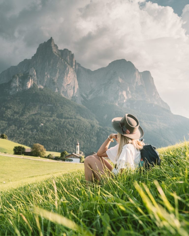 Woman looks at dramatic mountain in the Dolomites in Northern Italy