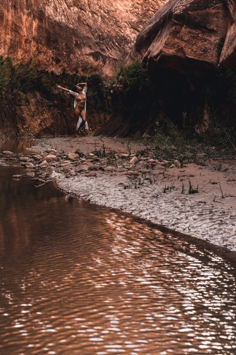 A black woman in an open slip explores the canyons of Escalante