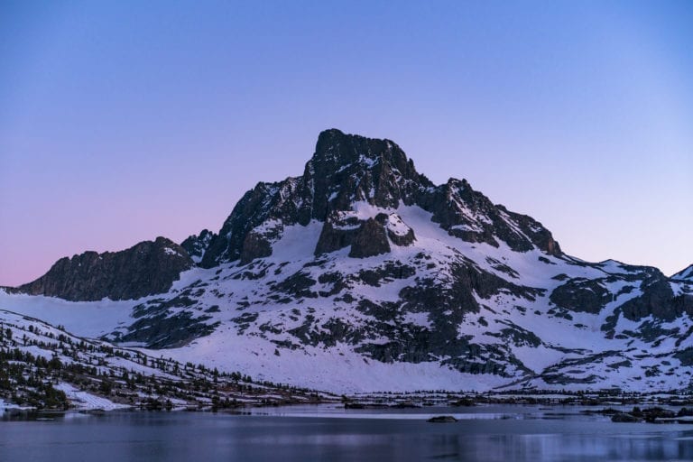 Banner Peak is illuminated at sunset with 1000 Island Lake in the forground