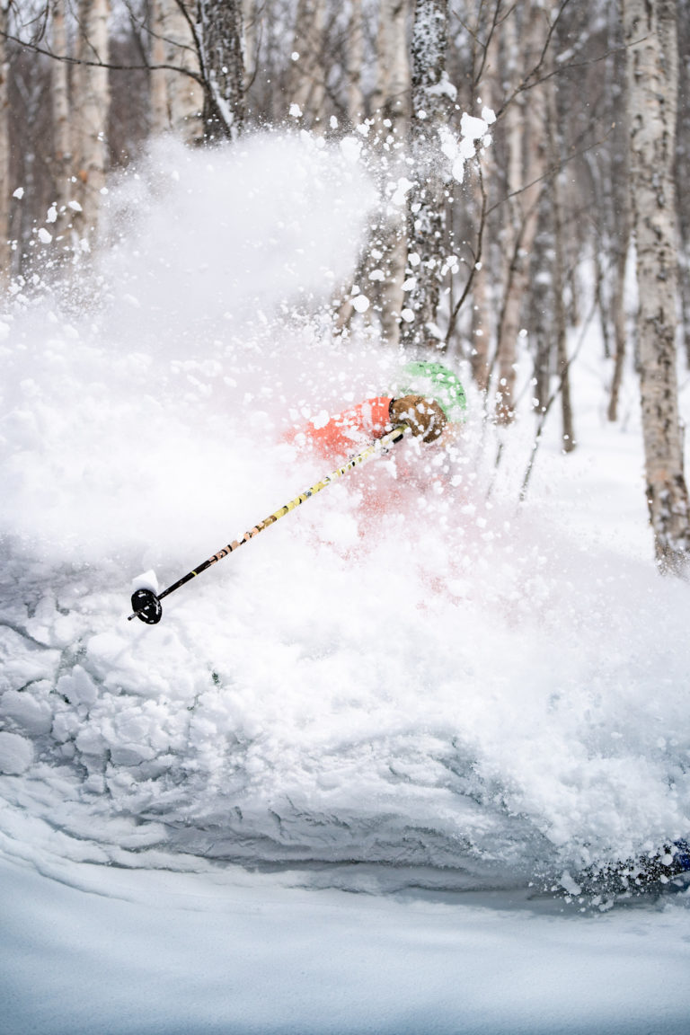 A man skis through deeps snow in Japan