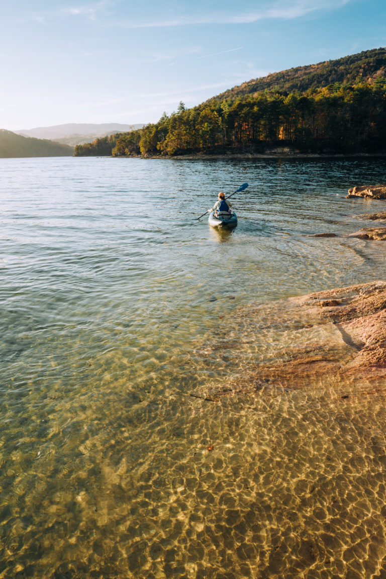 A female kayaker leaves the shore of Lake Jocassee in South Carolina.