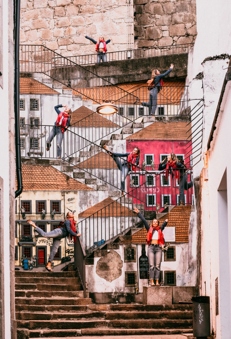 A woman poses in many places on a staircase mural in Porto, Portugal