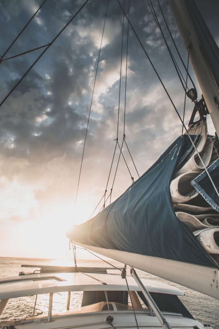 A beautiful sunset looking down the mast of a catamaran
