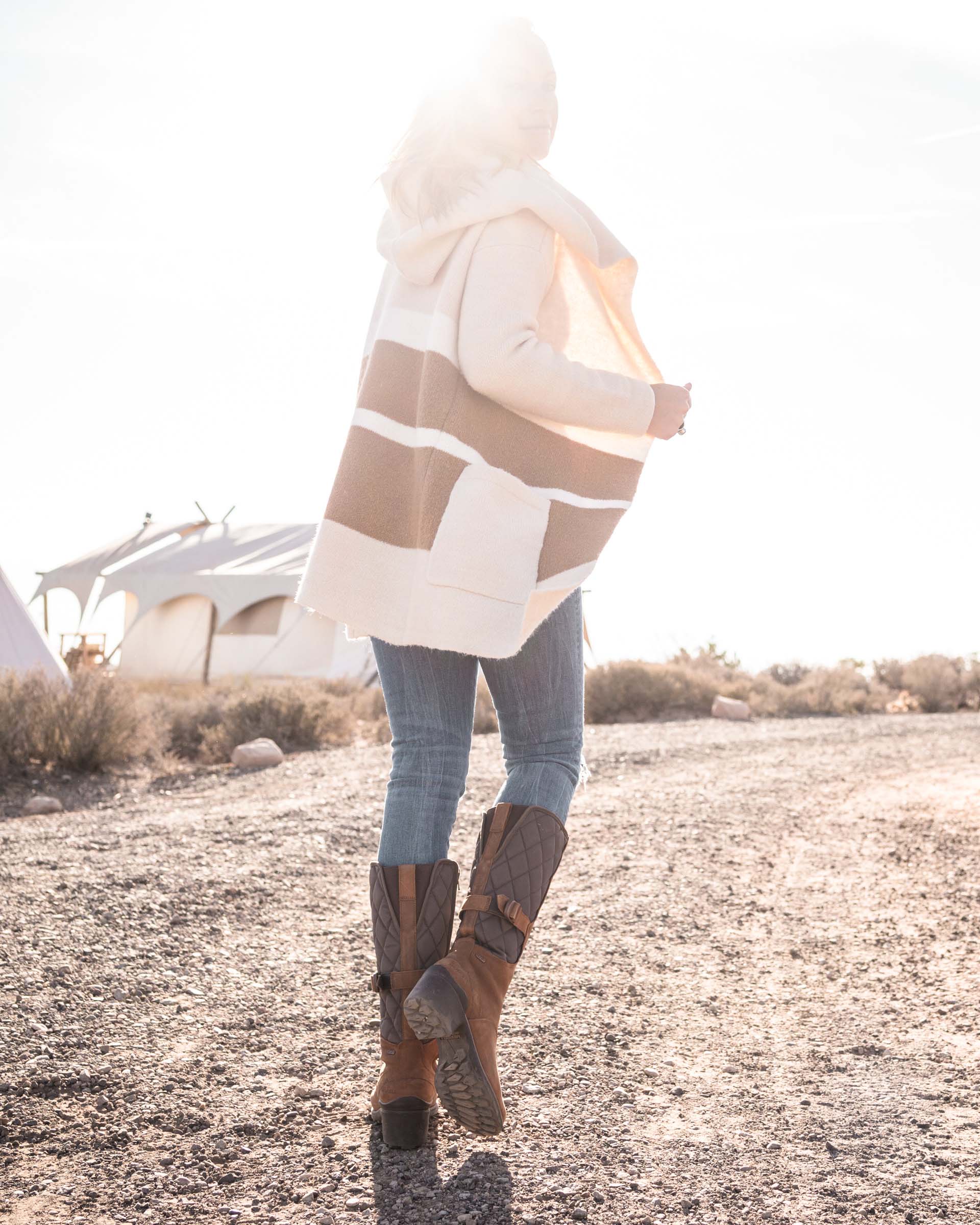 Sarah Herron wearing Merrell Boots at Undercanvas Moab as she walks toward the sun