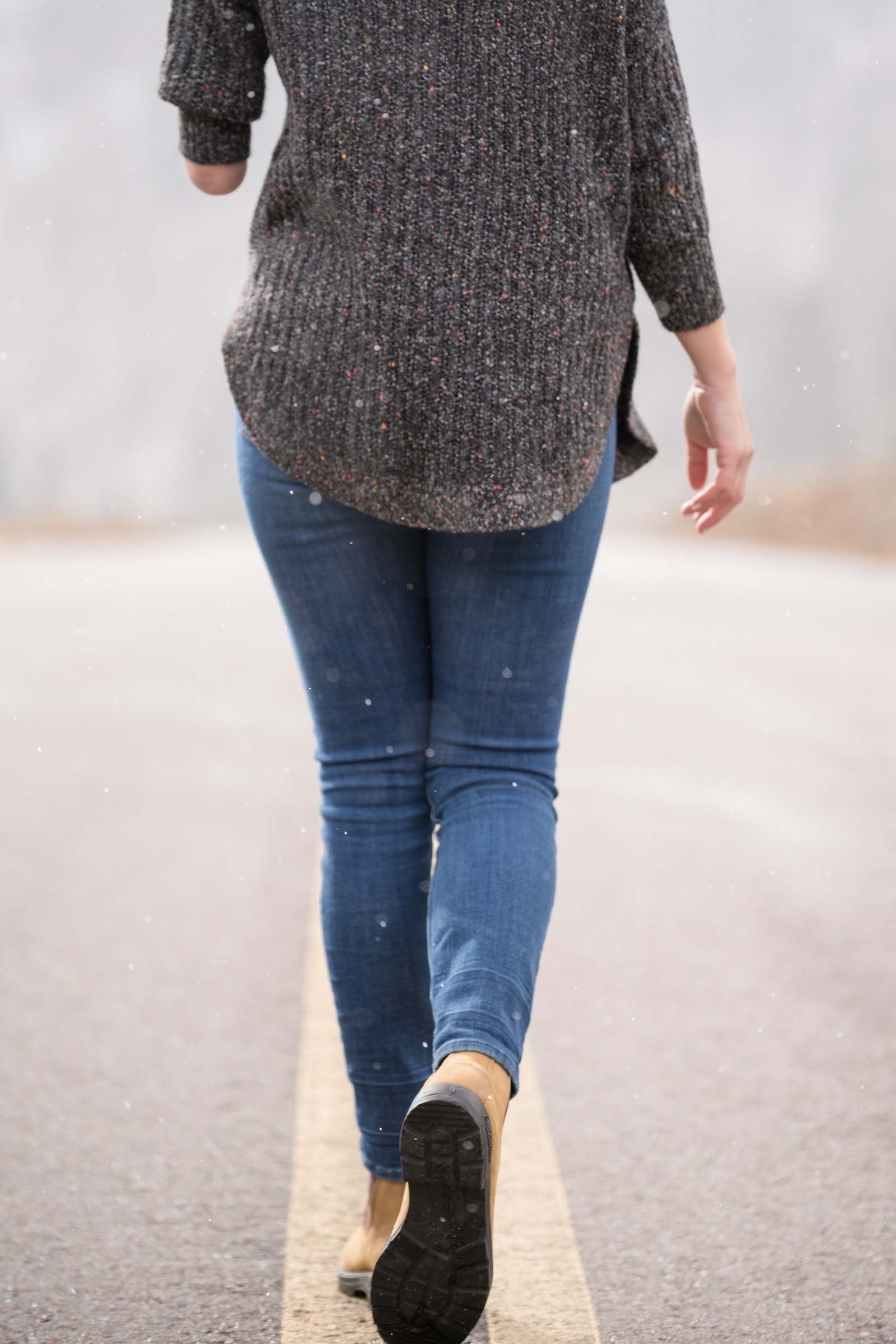 Sarah Herron walks down the road in her blundstone boots