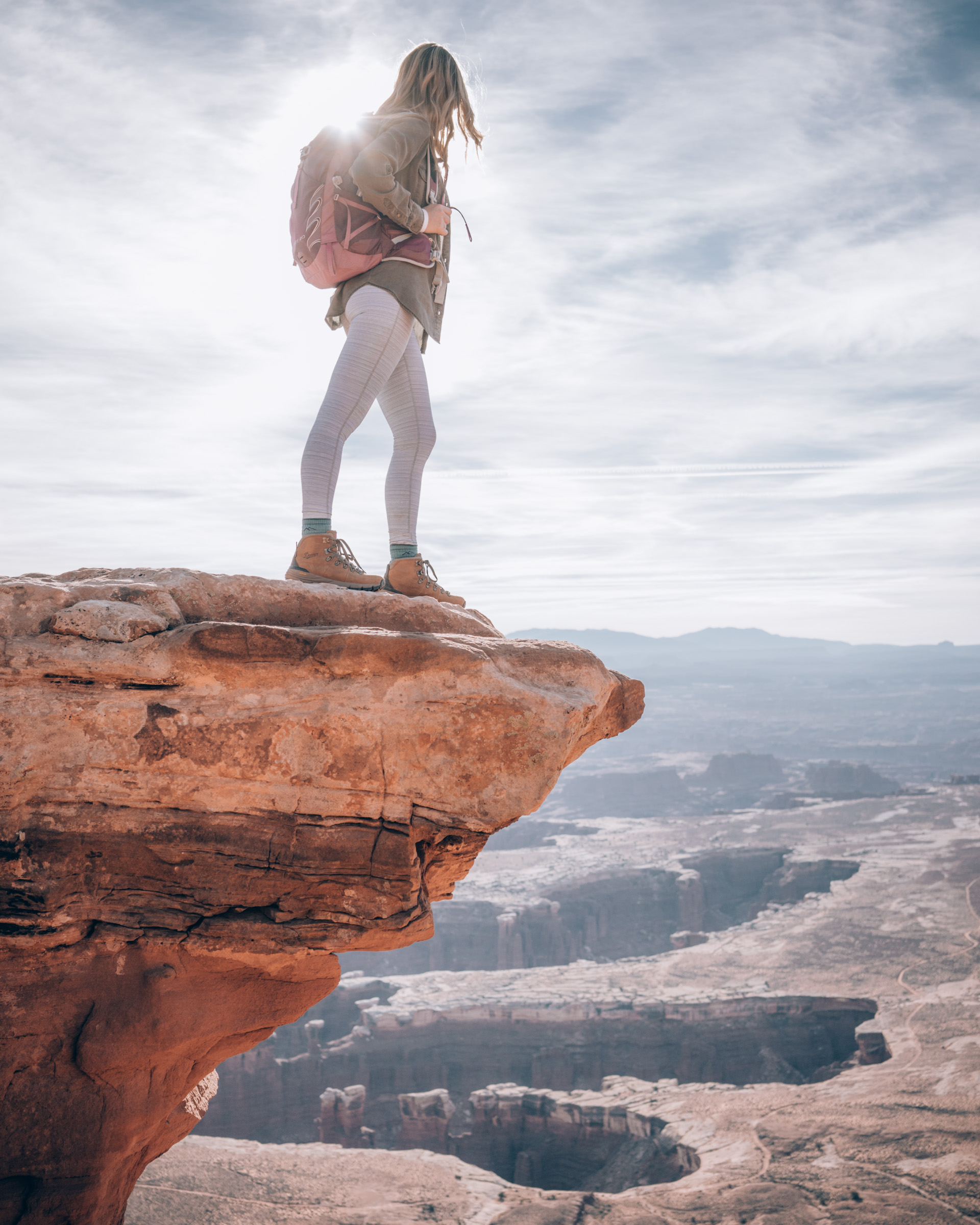 An athletic woman takes in the view at Island in the Sky, Canyonlands National Park