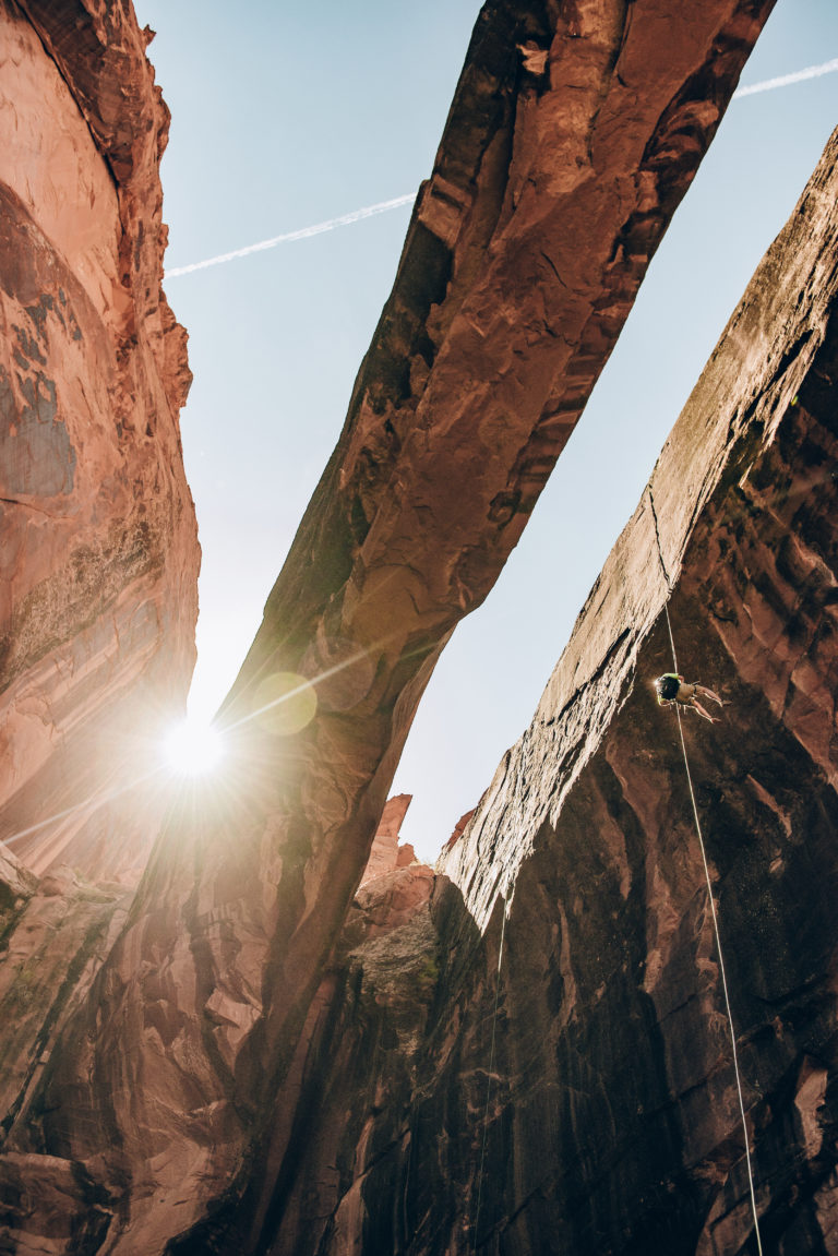 A rappeller descends through Morning Glory Natural Bridge in Negro Bill Canyon, near Moab, Utah.