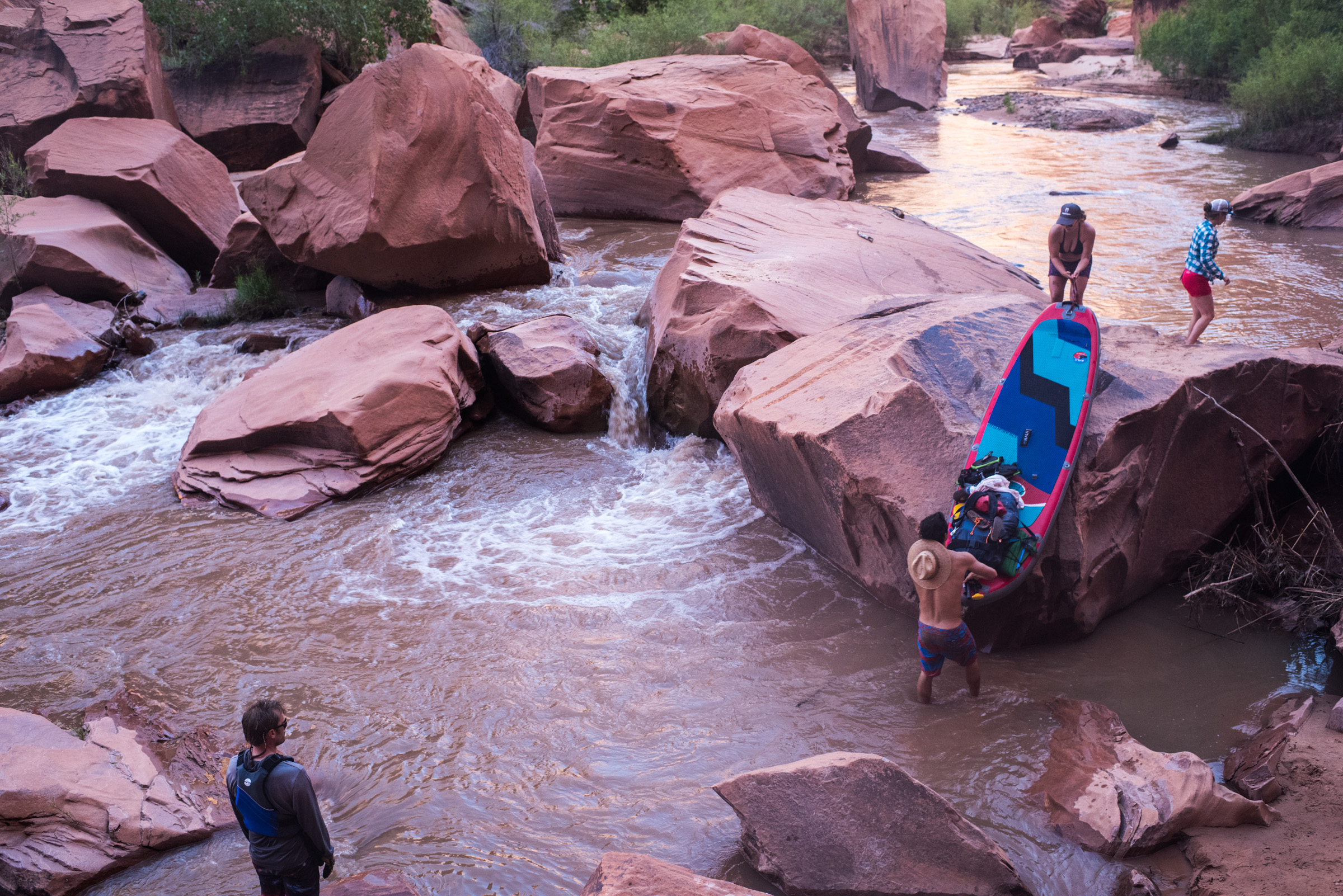People portage their boards on the Escalante River