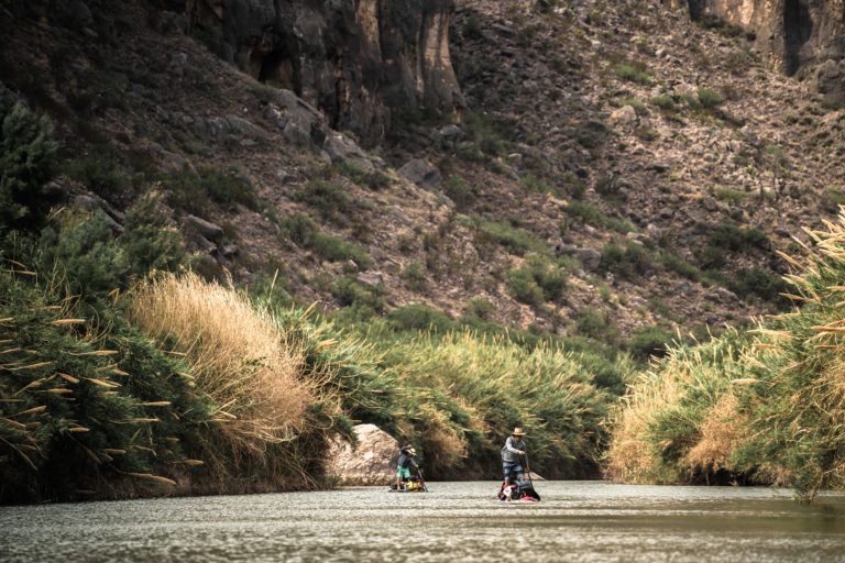 Two men paddle against the wind in the Lower Canyons section of the rio grande river