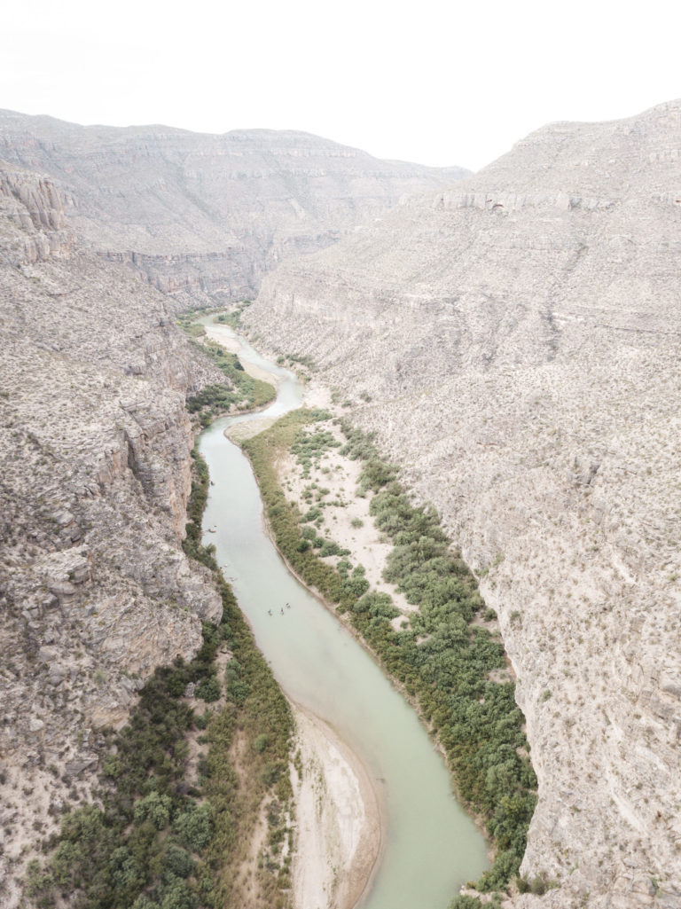 An aerial view of standup paddleboarders descending The Lower Canyons section of the Rio Grande River on the Texas and Mexico border.
