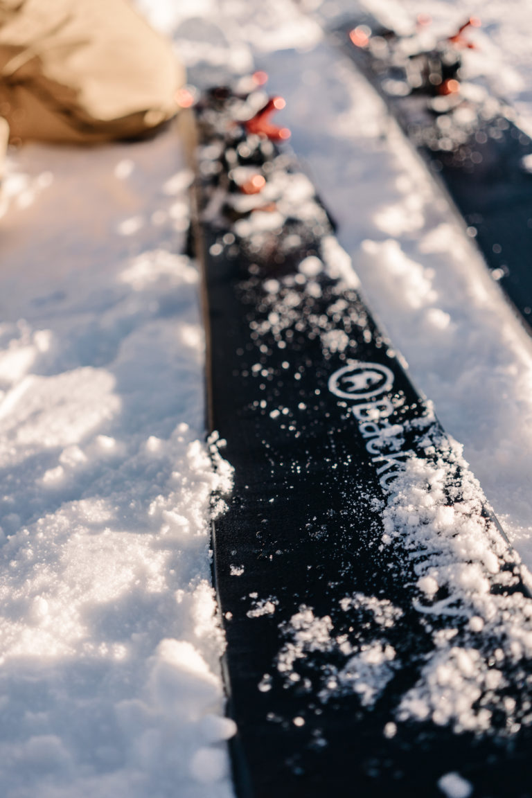 Backcountry skis covered in snow