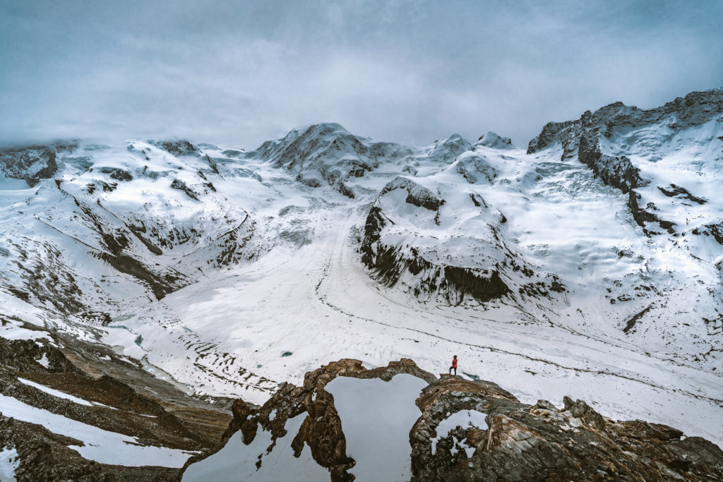 A woman looks down at the Gorner Glacier near Zermatt, Switzerland