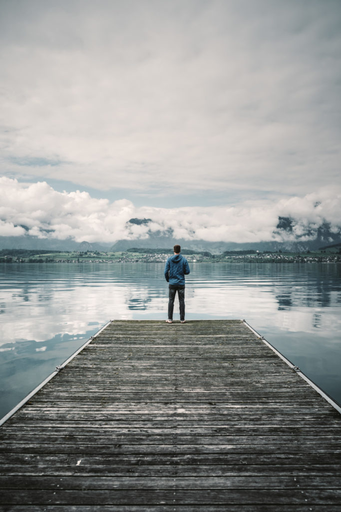A man looks over Lake Brienz in Switzerland.