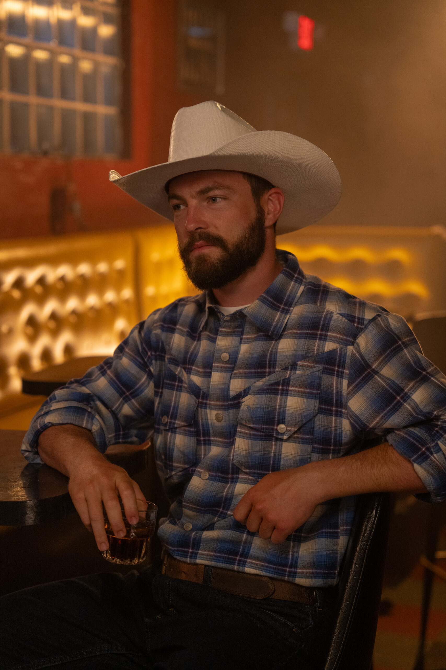 A man sits in a booth at Nickel City Bar.